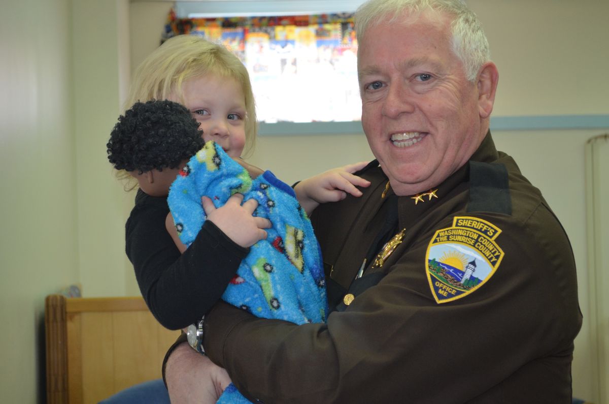 Washington County Sheriff Barry Curtis and a young student at the Washington County Community College's Early Learning Program.